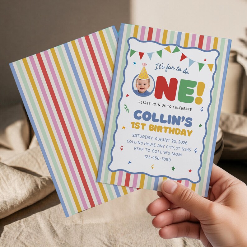 May include: A rectangular birthday invitation card featuring a colorful vertical striped border and a white center panel with a scalloped blue edge. The text reads It's fun to be ONE! Collin's 1st Birthday, Saturday, August 20, 2026, with details.