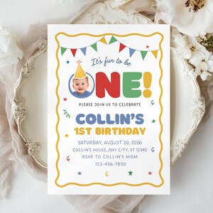 May include: A birthday invitation with a yellow border and colorful accents. The text reads "It's fun to be ONE!" with a photo of a baby. The invitation is for Collin's 1st birthday, with date, time, and RSVP information.