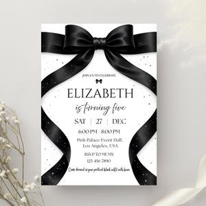 May include: A black and white invitation card with a large black bow at the top. The text reads "ELIZABETH is turning five" with event details. The invitation is for a party, with a request to wear black outfits with bows.