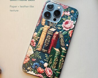May include: A slim phone skin with a floral and book design. The case features a dark teal background with pink roses, blue and orange flowers, and a stack of vintage books. The text "Slim Phone Skin" and "Paper + leather-like texture" is visible.