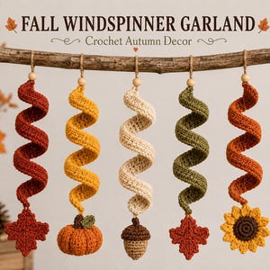 May include: A Fall Windspinner Garland featuring five crocheted spiral ornaments in red, yellow, cream, green, and orange. Each ornament hangs from a wooden bead and twine, ending in a crochet leaf, pumpkin, acorn, leaf, or sunflower motif.