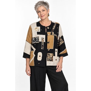 Könnte beinhalten: Eine langärmelige Jacke mit Patchwork-Design in Schwarz, Hellbraun und Creme. Das Kleidungsstück besteht aus verschiedenen rechteckigen und abstrakten Stoffbahnen mit Ziernähten, einem Rundhalsausschnitt und vier schwarzen Knebelverschlüssen.