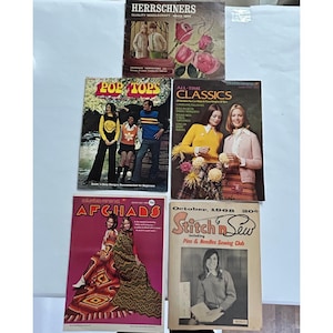 May include: A collection of five vintage craft and needlework magazines featuring colorful covers with photography of knitwear, crochet afghans, and floral illustrations. Titles include Herrschners, Pop Tops, All-Time Classics, Columbia Minerva Afghans, and Stitch n Sew.