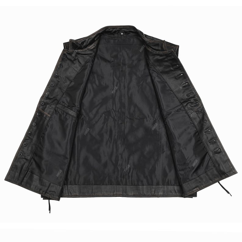 May include: Open view of a black leather jacket with a button-up front. The jacket has a classic design with a notched collar, multiple pockets, and a full lining. The leather appears worn, giving it a vintage look. The jacket is unbuttoned, revealing the interior.