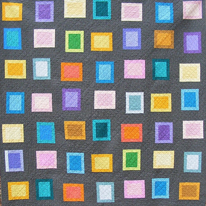 May include: A quilt with a gray background and a grid of colorful squares. The squares are in various shades of blue, green, orange, pink, yellow, and purple.