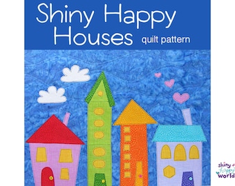May include: A quilt pattern for making a colourful quilt with houses. The houses are green, orange, pink, and blue. The quilt pattern is called "Shiny Happy Houses".