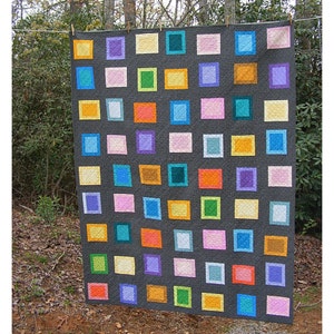 May include: A colorful quilt with a gray background and squares of various colors, including pink, orange, yellow, green, blue, and purple.