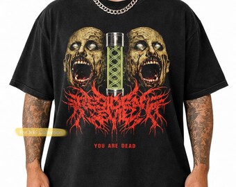May include: Black t-shirt featuring a graphic design with two screaming zombie heads and a glowing green vial. The text "RESURRECT" is in red, with "YOU ARE DEAD" below. The shirt has a vintage, worn look.