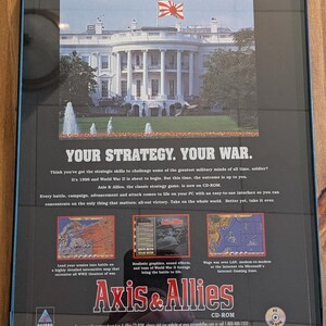 May include: Framed Axis & Allies CD-ROM game box. The image features the White House with a Japanese flag, and the text "YOUR STRATEGY. YOUR WAR." The box includes game screenshots and the Hasbro Interactive logo.