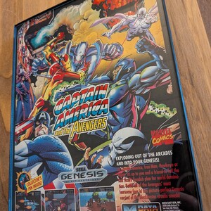 Puede incluir: Una caja de cartucho de juego de Sega Genesis para "Captain America and the Avengers". La caja presenta ilustraciones coloridas de estilo c&oacute;mic del equipo de los Vengadores, incluyendo al Capit&aacute;n Am&eacute;rica, Iron Man y Hawkeye. El logotipo de Marvel Comics es visible.