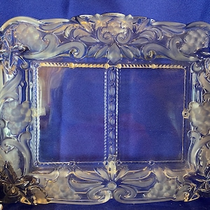 May include: A rectangular clear glass serving tray featuring a divided center section and an ornate border with frosted relief carvings of grape clusters, leaves, and scrolling vines. The glass surface is smooth with a decorative textured edge.