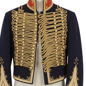 May include: A navy blue military-style jacket with gold-colored rope detailing and gold buttons. The jacket has a red collar with gold accents and gold embroidery on the sleeves and edges. The jacket is a formal garment.