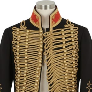 May include: Black military-style jacket with gold rope detailing and gold buttons. The jacket features a red collar with gold trim. The design is reminiscent of a historical uniform, with intricate embellishments.