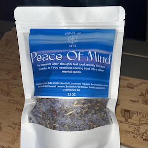 May include: A white pouch with a blue label featuring the text "Peace Of Mind." The label also includes the text "House of Omi." The pouch contains a mixture of dried herbs and flowers. The product is 12 OZ.