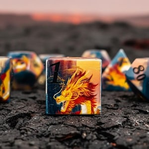 May include: A collection of multi-sided dice featuring a dragon design. The dice are in shades of blue, yellow, and orange, set against a dark backdrop. The central die displays the number 1.