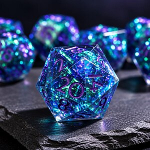 May include: A set of polyhedral dice made from translucent resin with a shimmering, iridescent interior of blue, green, and purple hues. Each die features sharp edges and deep purple engraved numbers, with a twenty-sided die in the foreground.