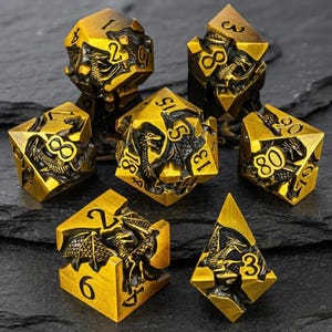 May include: A set of seven polyhedral dice featuring a metallic gold finish and black recessed dragon motifs. Each die displays engraved black numbers. The collection includes a d20, d12, d10, d10 percentile, d8, d6, and d4, all showcasing intricate dragon scales and wings integrated into the geometric faces.
