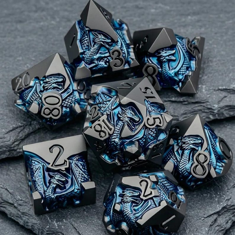 May include: A set of seven polyhedral dice featuring a metallic gunmetal finish with deep blue recessed dragon motifs. Each die displays raised black numbers, including a twenty-sided die, a twelve-sided die, and various other geometric shapes.