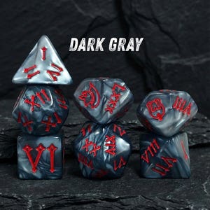 May include: Set of dark gray polyhedral dice with red numbering. The dice are in various shapes, including a d4, d6, d8, d10, d12, and d20. The text "DARK GRAY" is displayed above the dice.