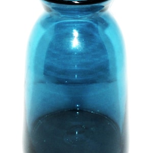 May include: A clear, teal-colored glass vase with a rounded body and a slightly flared opening. The vase has a dark blue rim and a smooth, reflective surface. The vase is empty and stands against a white background.