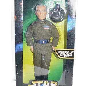 May include: A set of three ceramic mugs with a speckled, matte finish. The mugs are in shades of cream, light gray, and dark gray. Each mug has a simple, minimalist design and a rounded handle.