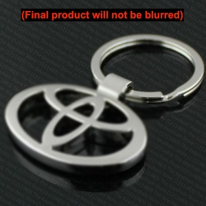 May include: Silver-colored Toyota logo keychain. The keychain features the Toyota emblem in an oval shape with a key ring attached. The design is simple and modern, suitable for car enthusiasts.