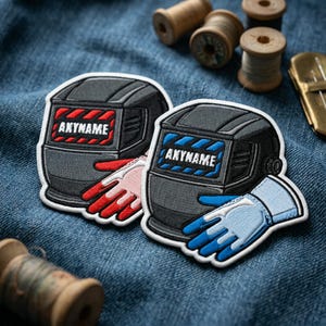 May include: Two embroidered patches featuring a welding helmet design. One has a red and black color scheme, the other blue and black. Both have the text "ANYNAME" on the front, and are paired with matching gloves.