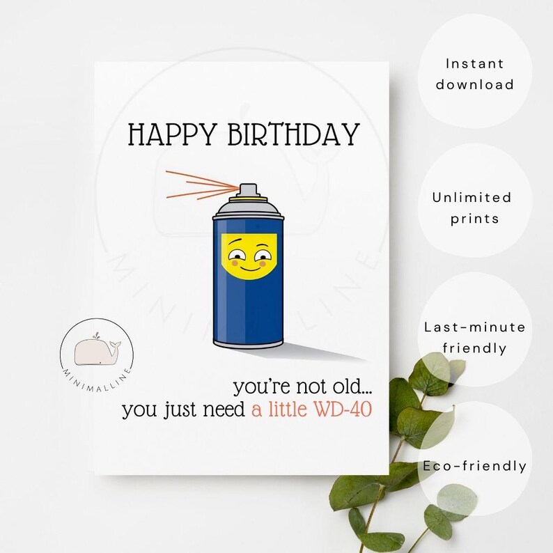 May include: A white greeting card featuring a blue spray can illustration with a yellow smiling face. The text reads HAPPY BIRTHDAY at the top and you're not old... you just need a little WD-40 at the bottom. A small whale logo is visible.
