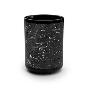 May include: Black ceramic mug featuring a white star map design. The mug displays constellations like Orion and Pleiades, with star names in white. A stylish and functional item for astronomy enthusiasts.