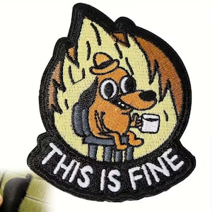 May include: Embroidered patch featuring a cartoon dog sitting in a chair, holding a mug, with flames around it. The text "THIS IS FINE" is displayed in white on a black banner below the dog.