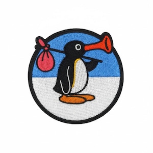 May include: Embroidered patch featuring a cartoon penguin with a red beak and a red bag over its shoulder. The penguin is black and white, set against a blue and white background within a black circular border. The patch is designed for apparel.