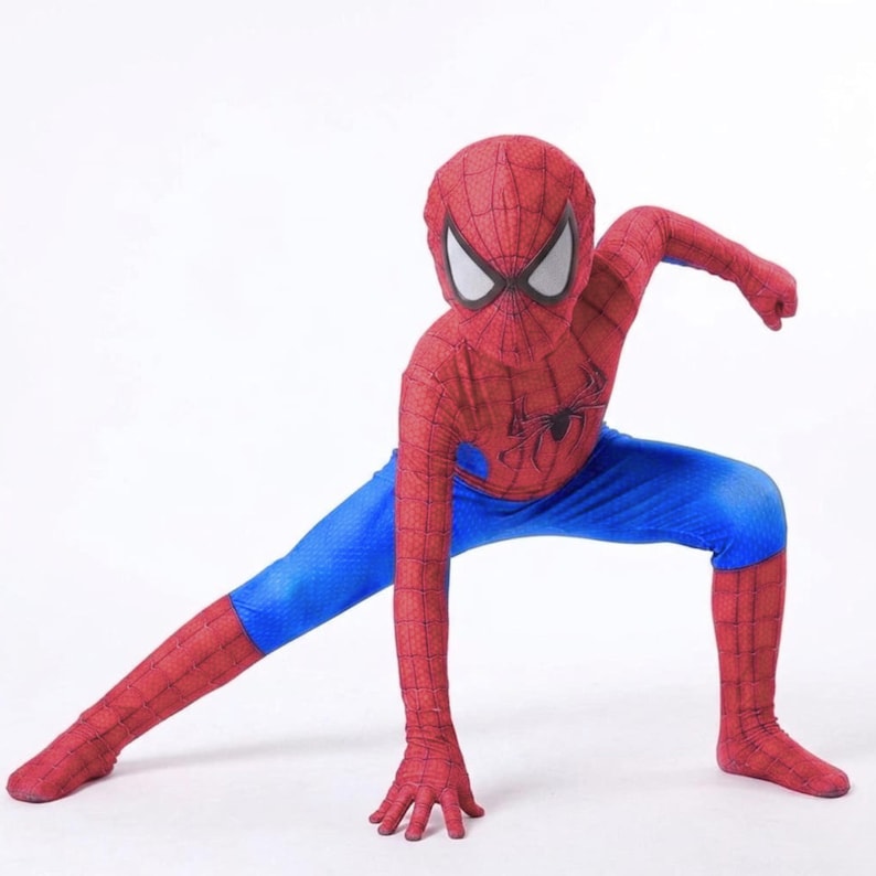 May include: A red and blue Spider-Man costume. The costume features a red mask with white eye shapes, a red body with a black spider emblem, and blue pants. The person is in a crouching pose with one arm extended.