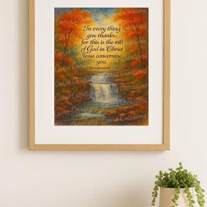 May include: Framed artwork featuring a scenic waterfall landscape with autumn foliage. The artwork includes the text "In every thing give thanks: for this is the will of God in Christ Jesus concerning you. 1 Thessalonians 5:18."