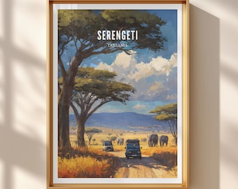 May include: Framed art print of the Serengeti in Tanzania. The landscape features a dirt road, safari vehicles, elephants, and acacia trees under a cloudy sky. The word "SERENGETI" is printed at the top, with "TANZANIA" below it.