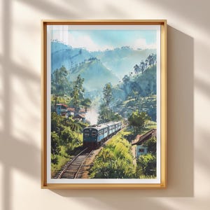May include: Watercolour painting of a train journeying through a verdant mountain landscape. The train is blue and white, with steam rising from its engine. The artwork is framed in a gold-coloured wooden frame.