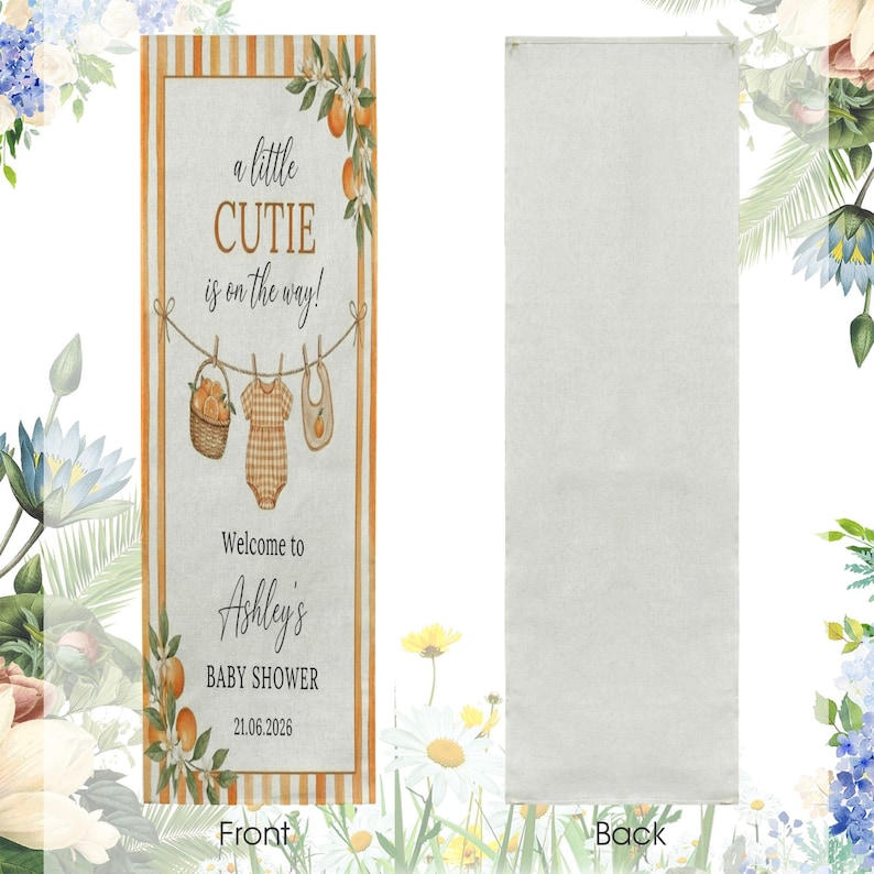 May include: A rectangular fabric banner featuring orange stripes on the edges and a central design with the text a little CUTIE is on the way! Welcome to Ashley's BABY SHOWER 21.06.2026, illustrated with a clothesline, basket, onesie, and bib.