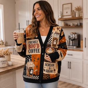May include: A long-sleeve button-down cardigan featuring a black, orange, and cream patchwork pattern with coffee and ghost graphics. The text reads Freshly Boo'd Coffee and Scream & Sugar, accented with spiderwebs, stars, and pumpkin illustrations.