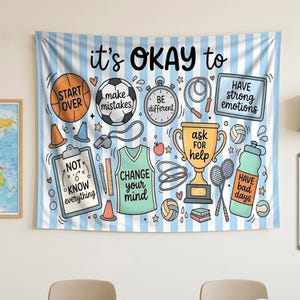 May include: A light blue and white striped wall tapestry featuring various sports equipment illustrations and motivational text including "it's OKAY to", "START OVER", "make mistakes", "BE DIFFERENT", "NOT KNOW everything", "CHANGE your mind", "ask FOR help", "HAVE strong emotions", and "HAVE bad days".