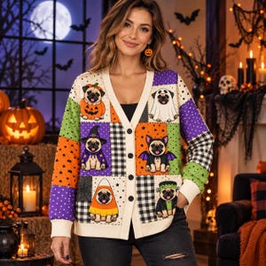 May include: A V-neck button-down cardigan featuring a patchwork design with various Halloween-themed pug illustrations, including a pug in a pumpkin, a ghost, a witch, a bat, a candy corn, and a Frankenstein monster, set against orange and purple.