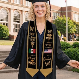May include: A black graduation sash with gold accents, featuring butterfly designs, the text "Your Name", "RN", and "Graduate". It includes the Mexican and American flags, and the text "Class of 2026".