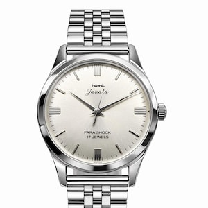 Może przedstawiać: Srebrny zegarek na rękę z jasną tarczą i bransoletą ze stali nierdzewnej. Tarcza zegarka wyświetla nazwę marki "Janata" oraz tekst "PARA SHOCK 17 JEWELS". Zegarek ma klasyczny design.