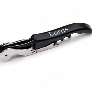 May include: A black waiter's corkscrew featuring a silver metal foil cutter and a spiral worm. The handle is matte black with the word Lotus printed in white lettering. This folding wine opener includes a hinged lever mechanism for bottle opening.