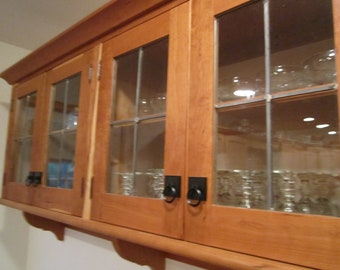 Custom cherry wall cabinet with leaded glass doors