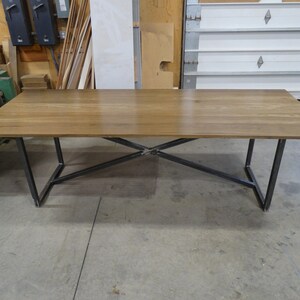 Modern rustic fumed oak dining table with a blackened steel base