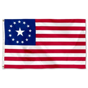 May include: A rectangular flag featuring a blue canton with a white star surrounded by 13 smaller white stars. The flag has 13 alternating red and white horizontal stripes. The flag is designed with grommets for hanging.