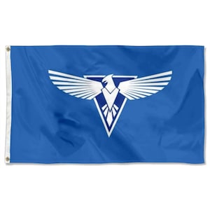 May include: A blue flag featuring a white eagle emblem with outstretched wings and a triangular base. The flag has grommets on the left side for hanging. The eagle design is centered on the flag.