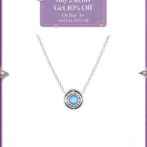 May include: A silver-toned necklace featuring a circular pendant with a central light blue stone surrounded by a black and silver geometric frame. The image includes a purple rectangular graphic with the text Buy 2 Items Get 10% Off Or Buy 3+ And Get 20% Off.