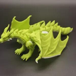 May include: A lime green dragon figurine with detailed scales, wings, and claws. The dragon is posed on a dark surface, showcasing its intricate design. The figurine is a fantasy-themed collectible.