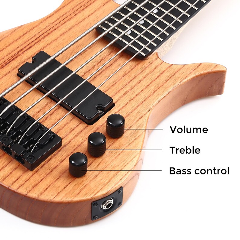K&ouml;nnte beinhalten: Nahaufnahme einer h&ouml;lzernen Bassgitarre mit schwarzer Hardware. Die Gitarre hat vier Saiten, schwarze Regler mit der Aufschrift "Volume", "Treble" und "Bass control" sowie einen schwarzen Tonabnehmer.
