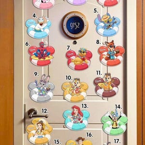 May include: A collection of colorful Disney character-themed door decorations. Each decoration features a character like Mickey Mouse or Ariel in a life preserver, with space for a name. The door also has a room number, 9152.